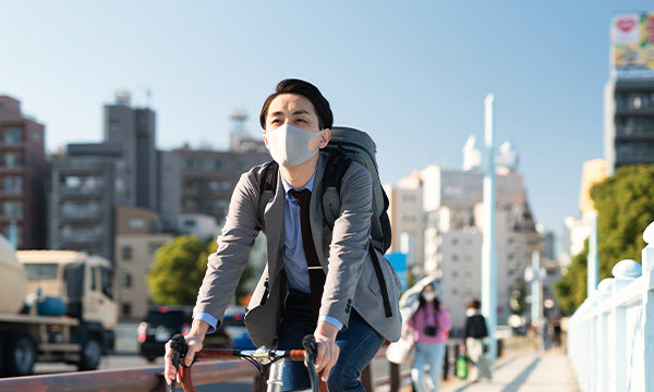 Man traveling by bike through busy city